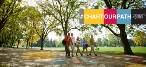 Official strategic renewal photo featuring students walking along alumni walk with johnston green in the background. Photo features hashtag #ChartOurPath