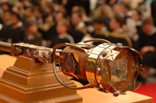 Photo of University of Guelph mace with graduating students in the background