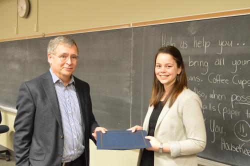 Photo of Warren Jestin presenting scholarship to Chloe Blais