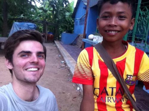 Cole poses with Cambodian student