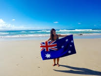 Katie Lo posing by the beach with the Australia flag