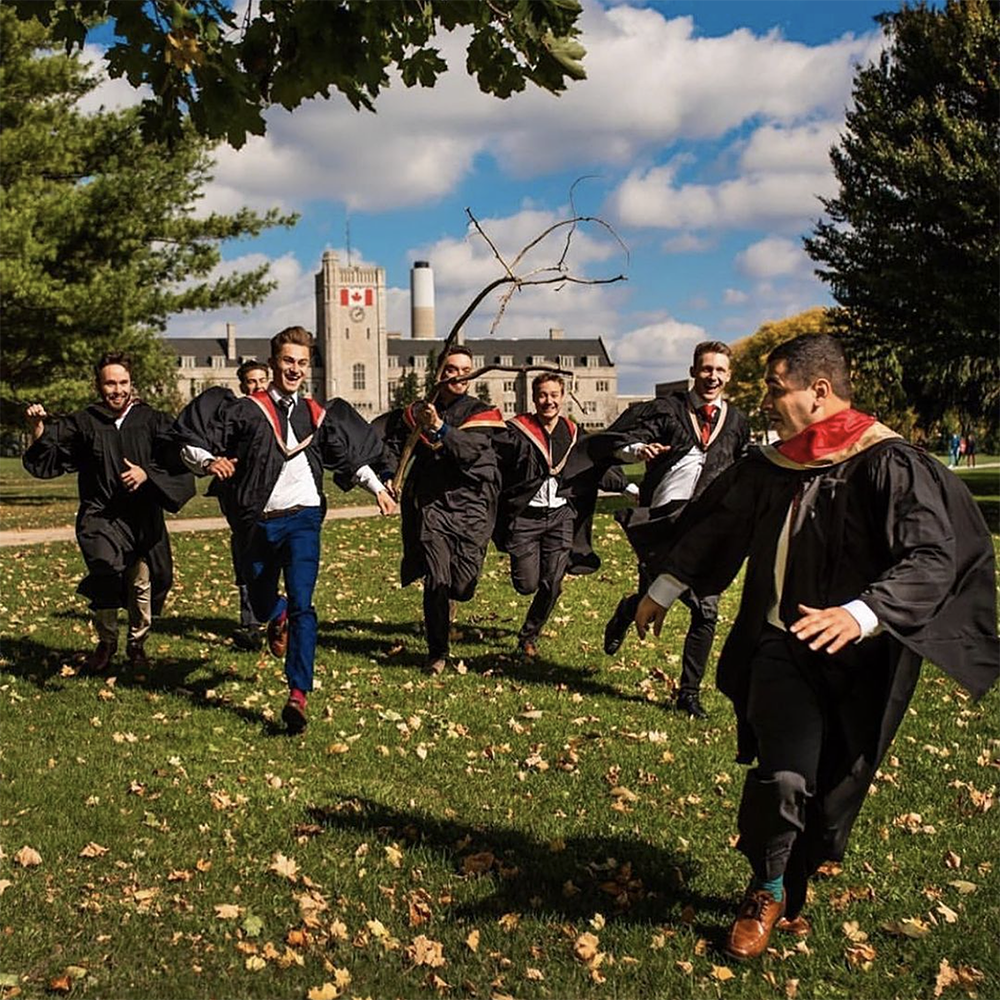Grads running on Johnston Green with Johnston Hall in the background