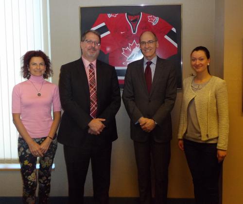 Photo of Brent McKenzie with Ambassador Morrison and two staff