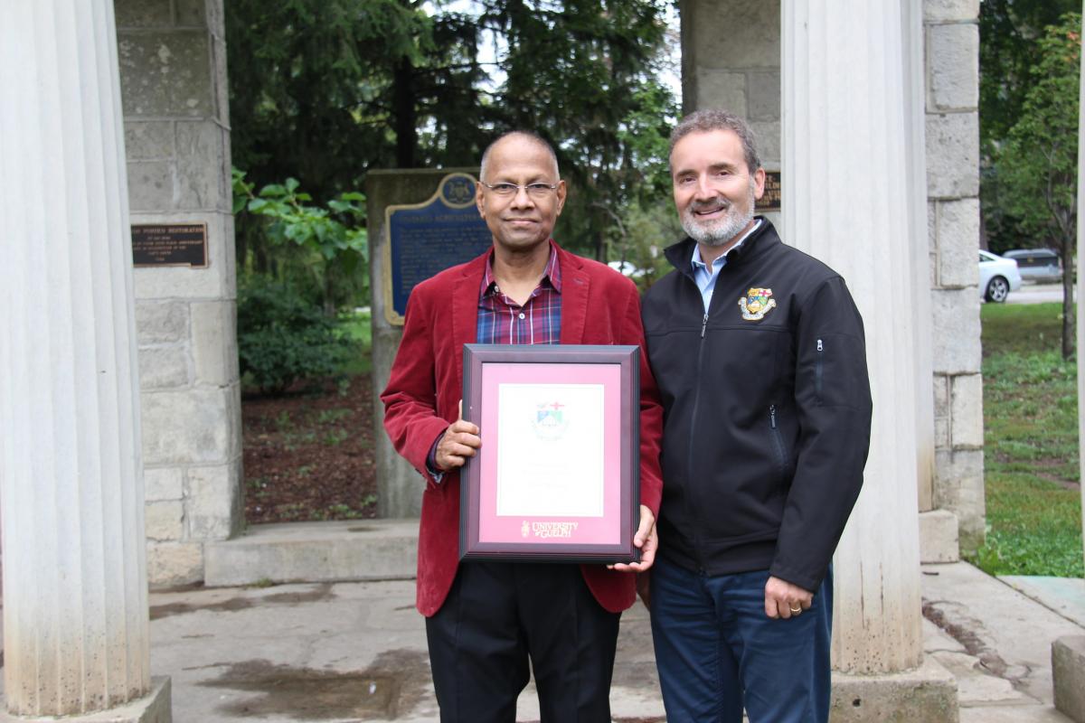 Amar receiving his award from Dean, Rene Van Acker.