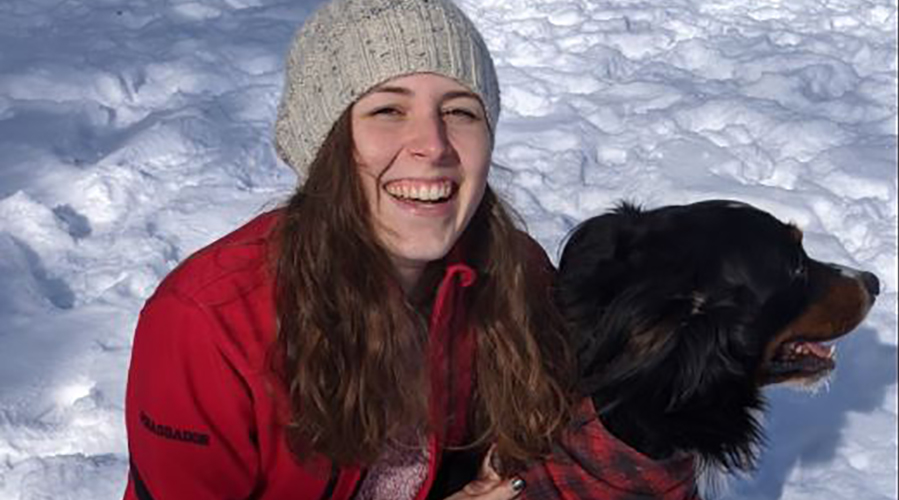 Gabi outside in snow with black dog