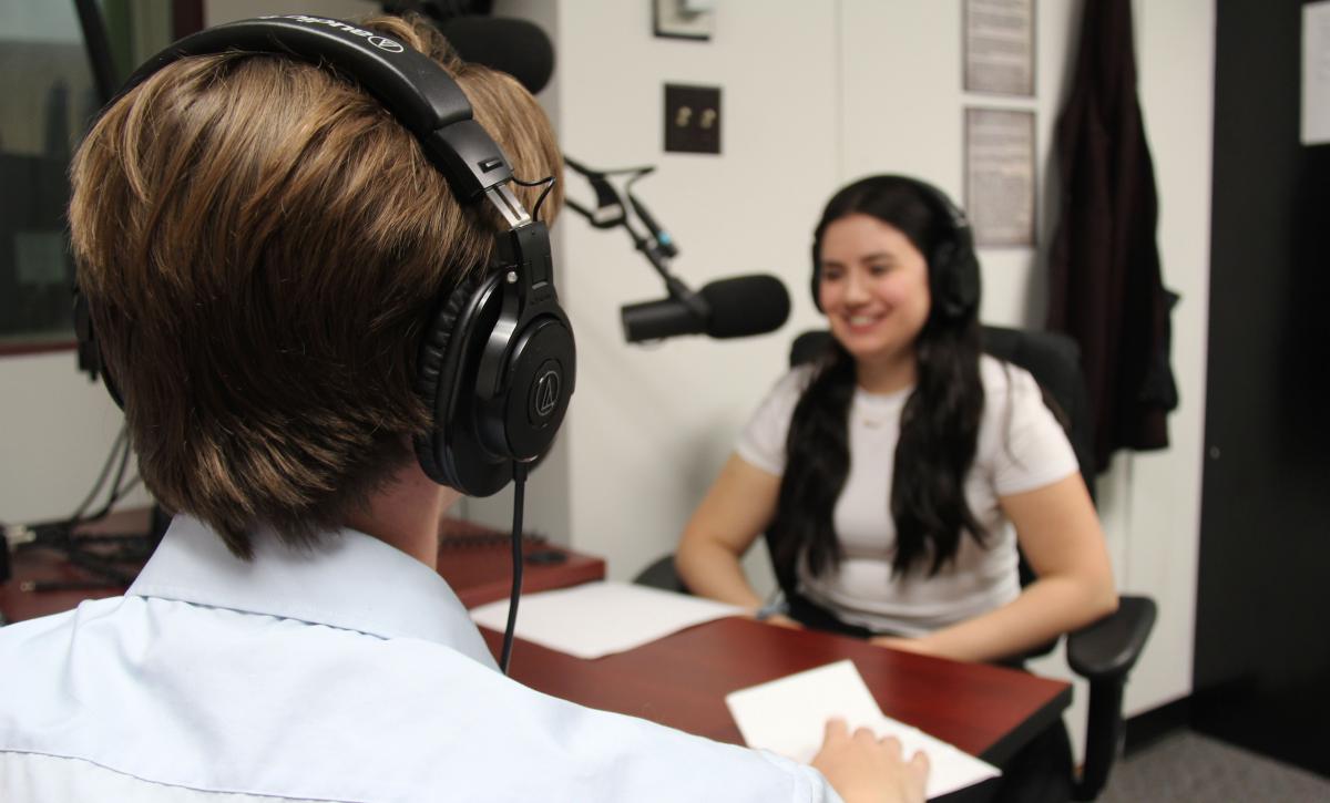 Two students in a recording studio.