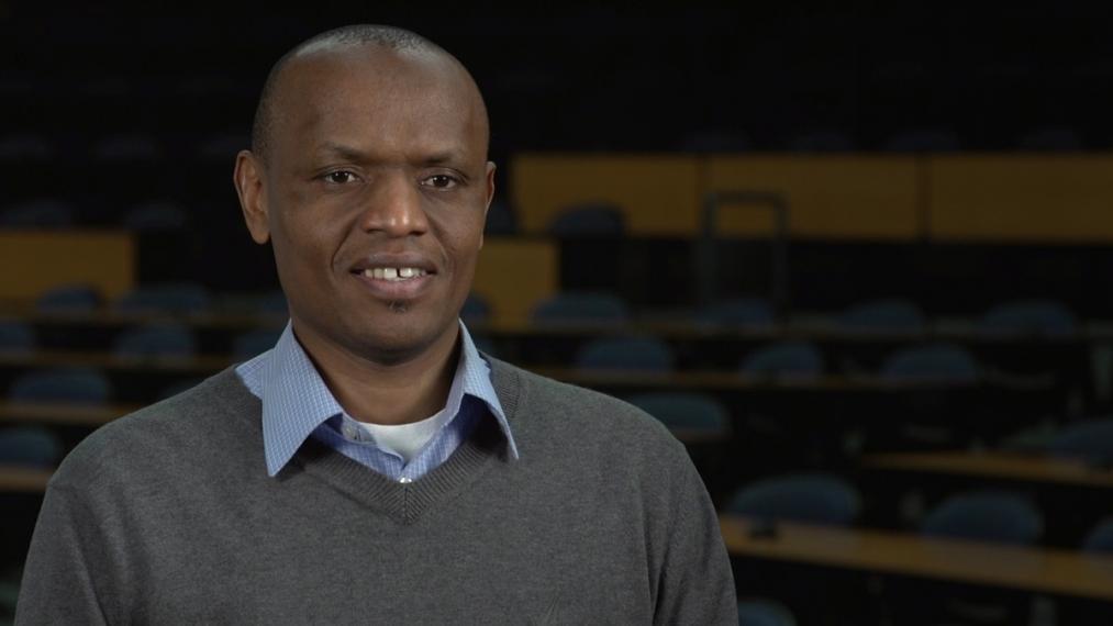 Elijah head shot sitting in empty lecture hall