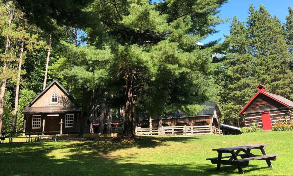 Several wooden stuctures and picnic benches