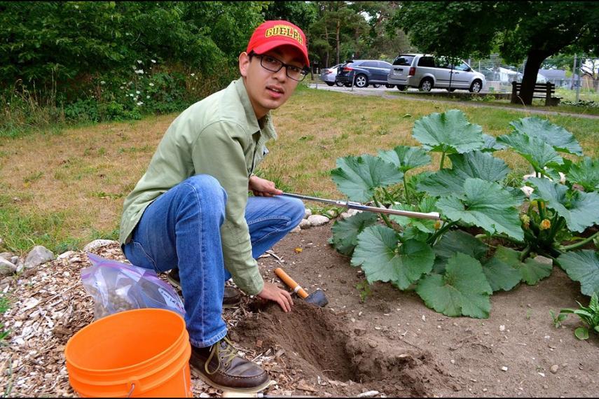 Fernando Montaño Lopez taking soil samples from a community garden plot.