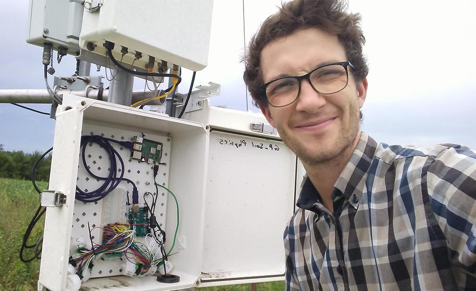 Gordon Bell standing in front of a weather station at the Elora Research Station.