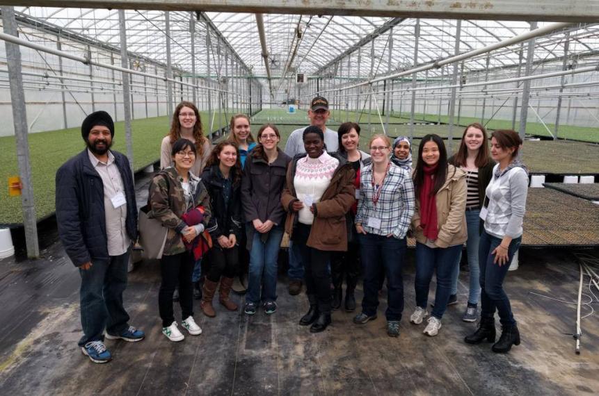 Group of students with Wayne Sonneveld of Lakeview Greenhouses inside large greenhouse