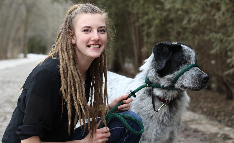 Lola poses with a dog.