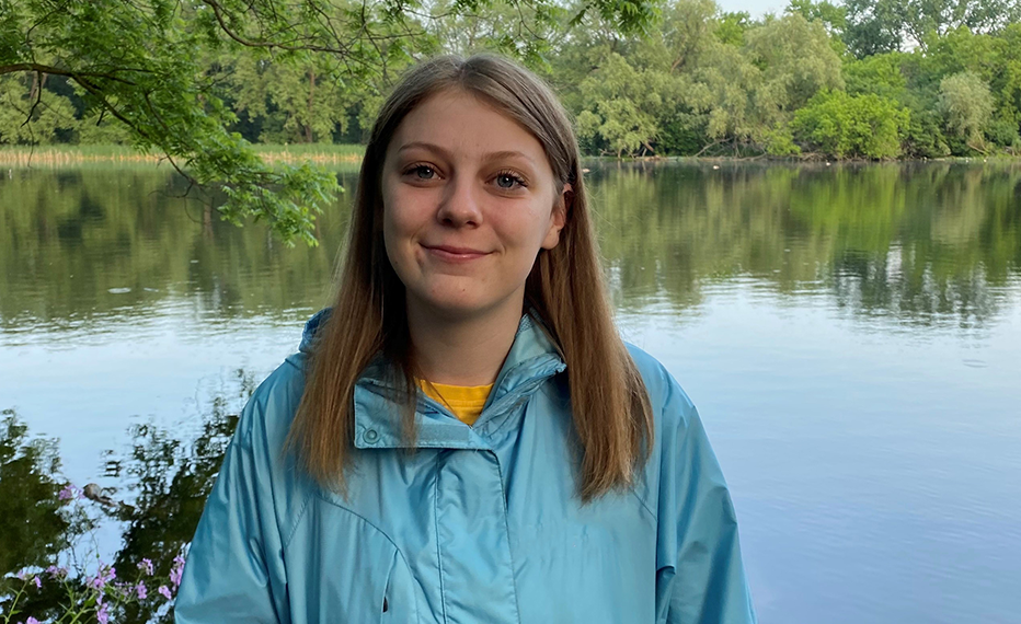 Head shot of Rebecca Lawson, standing in front of a body of water.