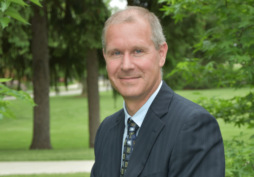 Simon Lachance with grass and trees behind him