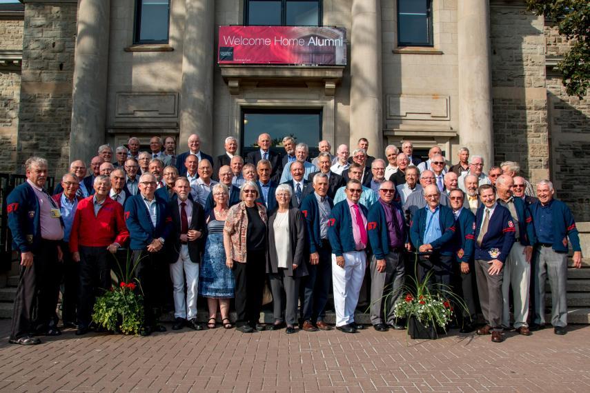 A group of alumni standing in front of Creelman hall.