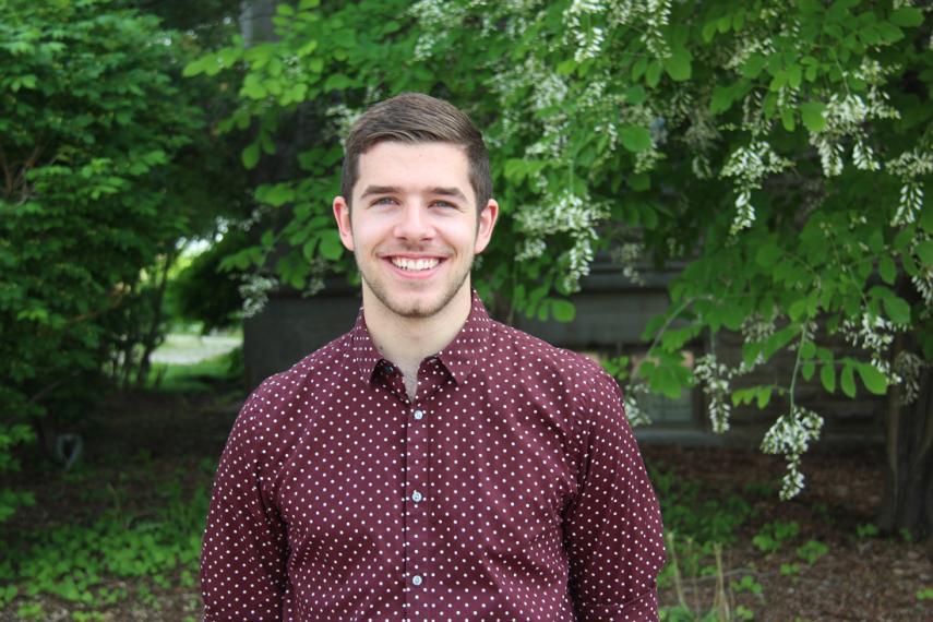 Jordan Terpstra standing in front of green trees