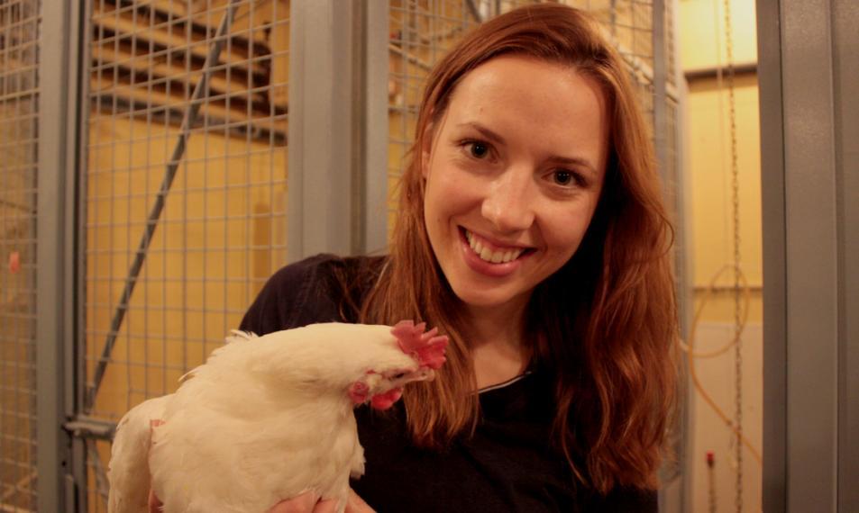 Krysta holds a white hen.