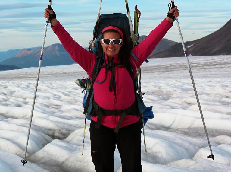 Laurissa wearing sunglasses and outdoor gear while treking on a glacier