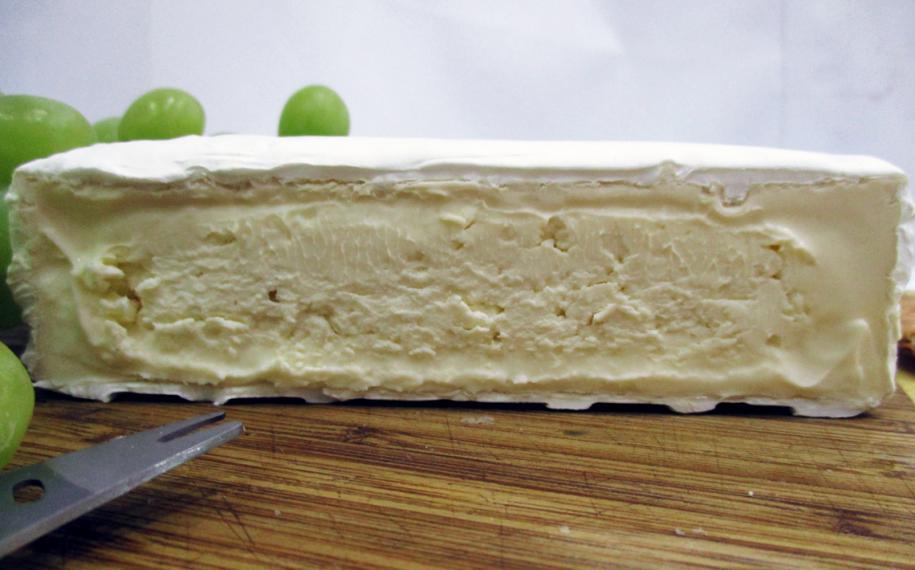 Large cross section of soft brie cheese