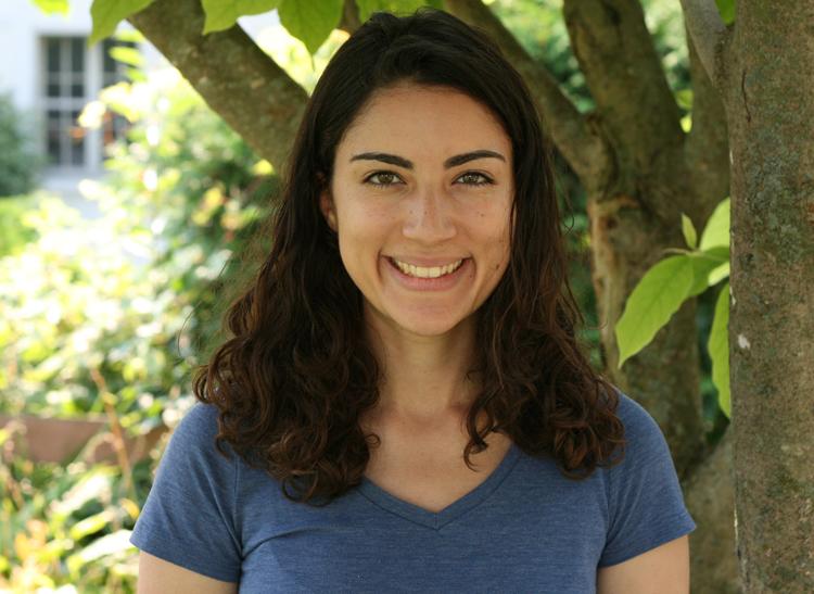 Valerie smiling, wearing a blue t-shirt outside