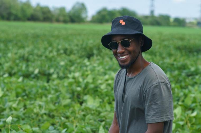 Head shot of Deus Mugabe standing in a field of soybeans.