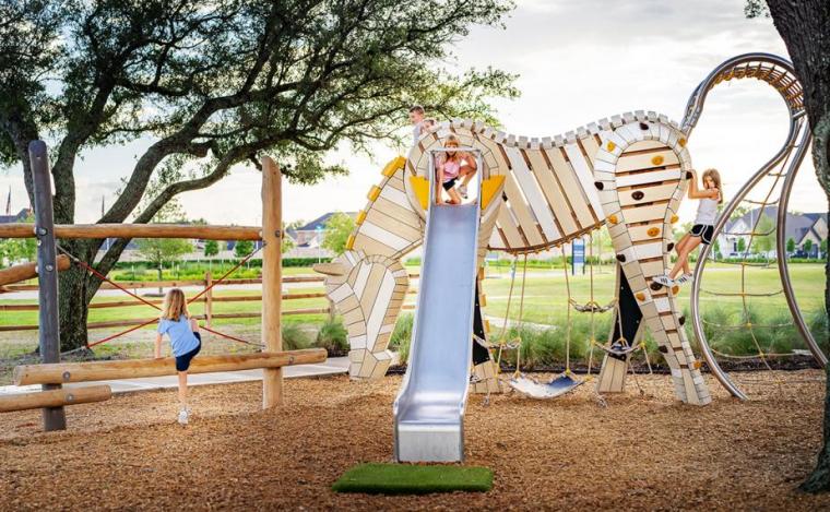 Kids playing at a playground designed by Earthscape Play.