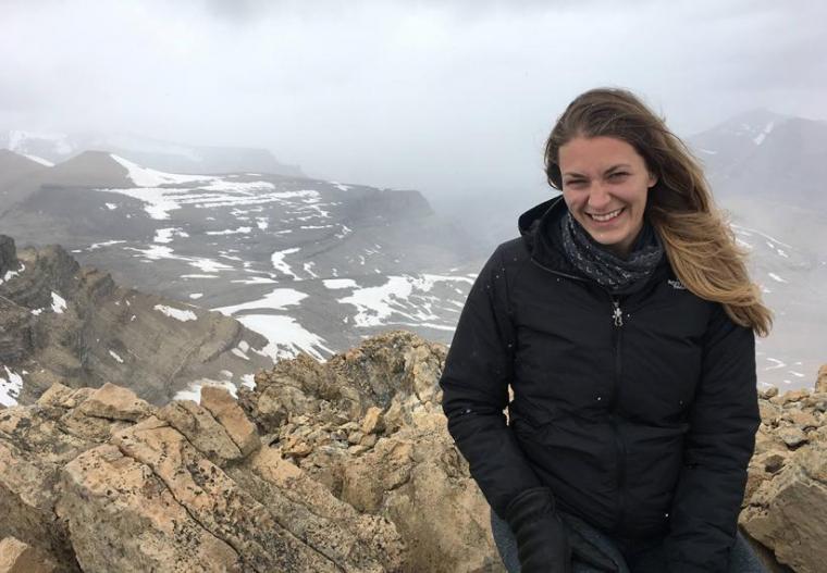 Melissa smiling with snow-covered mountains in the background