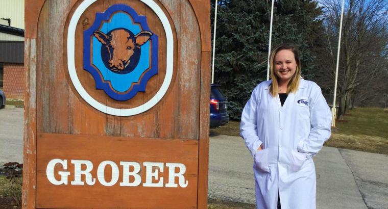 Nikki stands next to a large Grober sign.