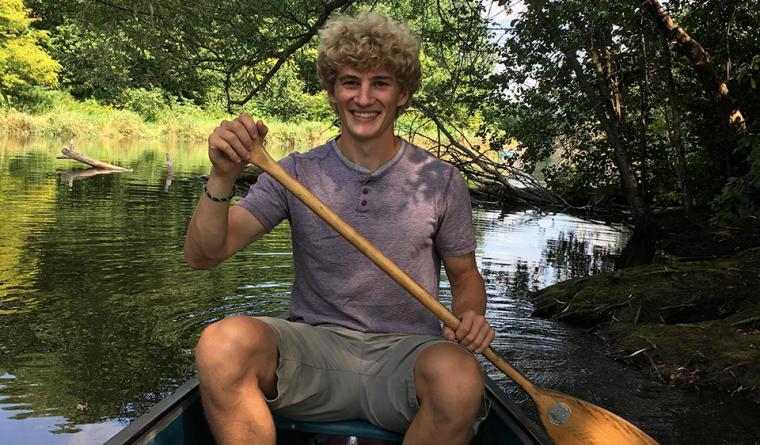 Owen sitting in a canoe.