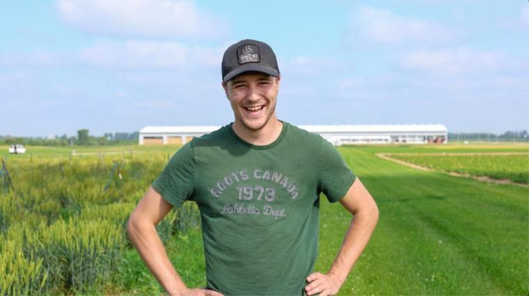 Riley standing outside in a field of wheat