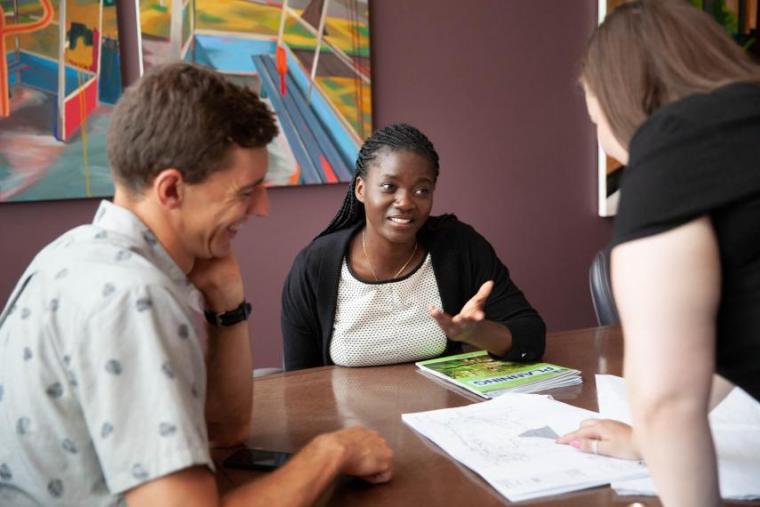 students in the rural planning masters program are discussing a project in a classroom