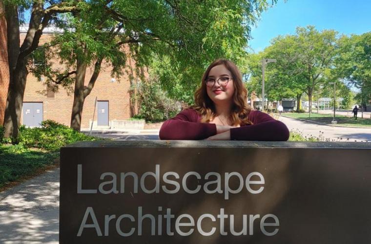 Tatijana standing in front of a sign that says landscape architecture.