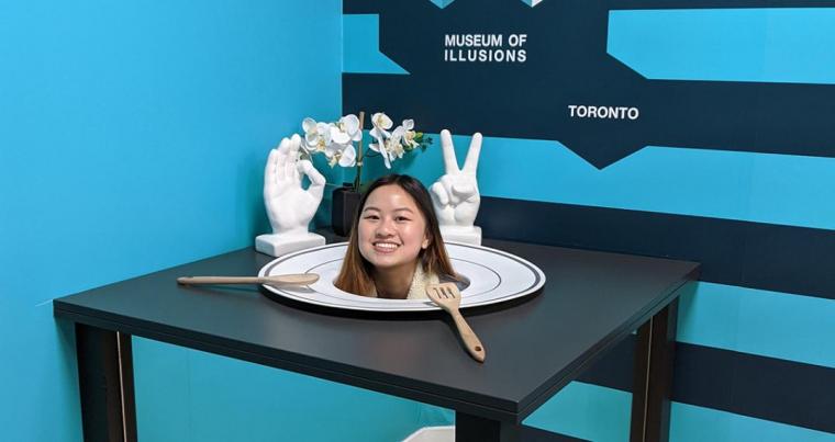 Victoria smiling beside a prop at the Museum of Illusions.