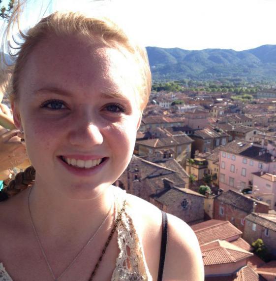 Chloe outside with Eurpoean village behind her in the distance