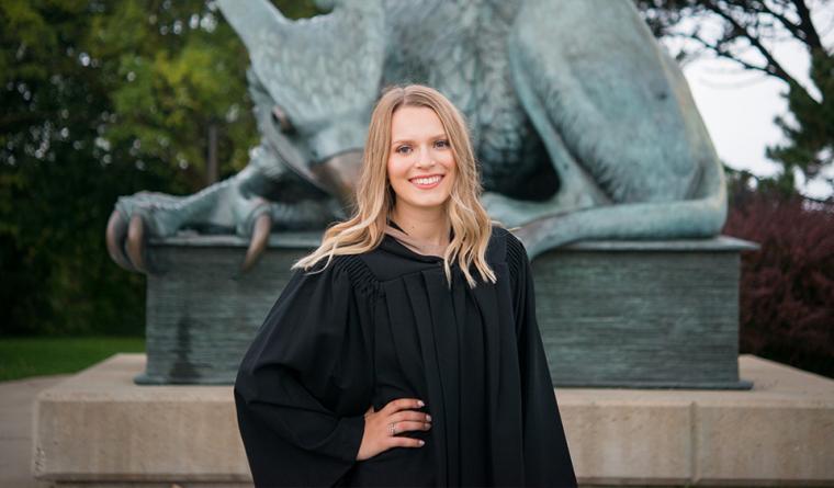 Head shot of Clarissa, standing in front of the Gryphon statue.