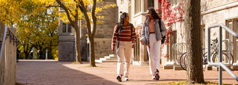 Two students walking outside of OAC