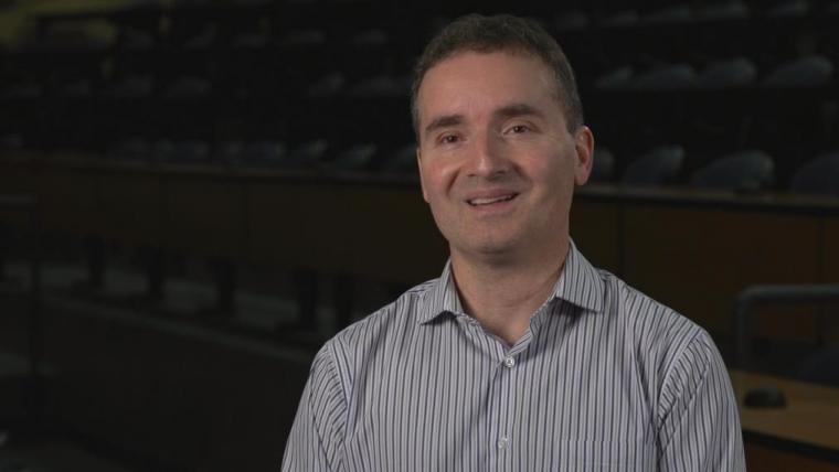 Rene Van Acker in dark lecture room