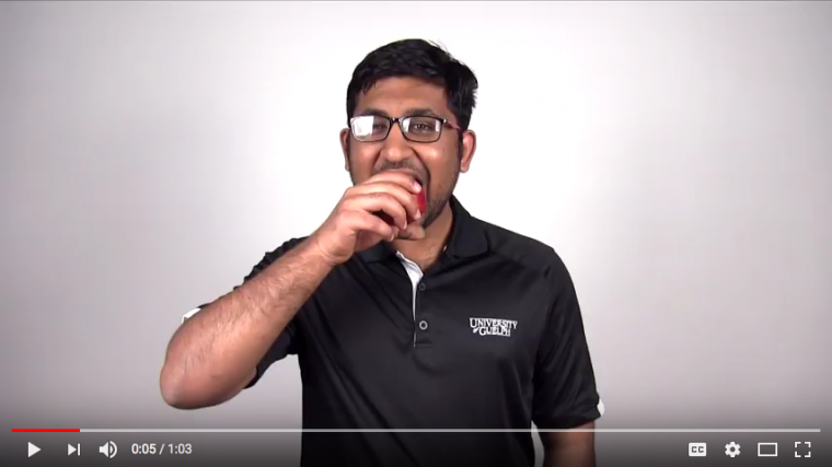 Screen shot of video player with Shan on screen biting into a nectarine
