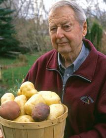 Garnet Richard Johnston holds a basket of potatoes.