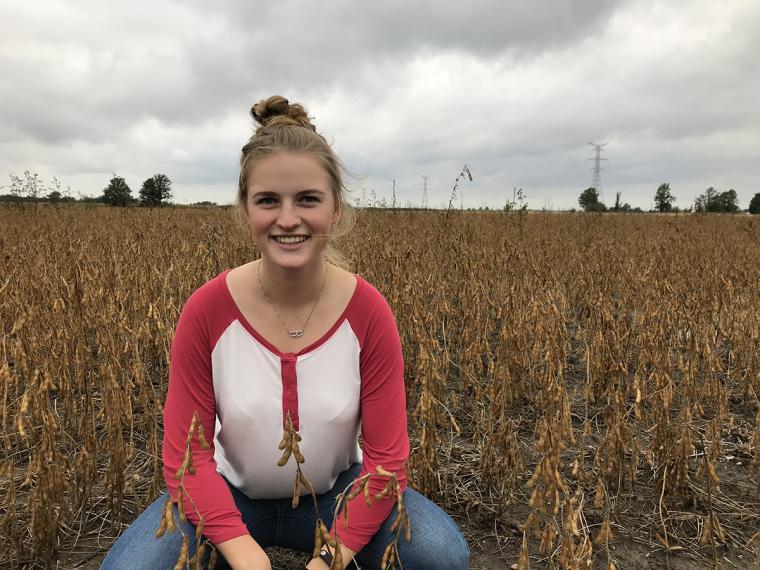 Head shot of Hannah in a field.