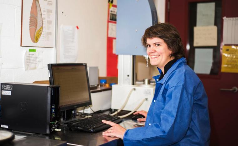 Prof. Iris Joye sits at computer in lab