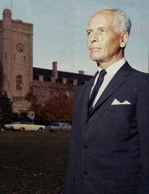 John Douglas MacLachlan stands on Johnston Green with Johnston Hall in the background.