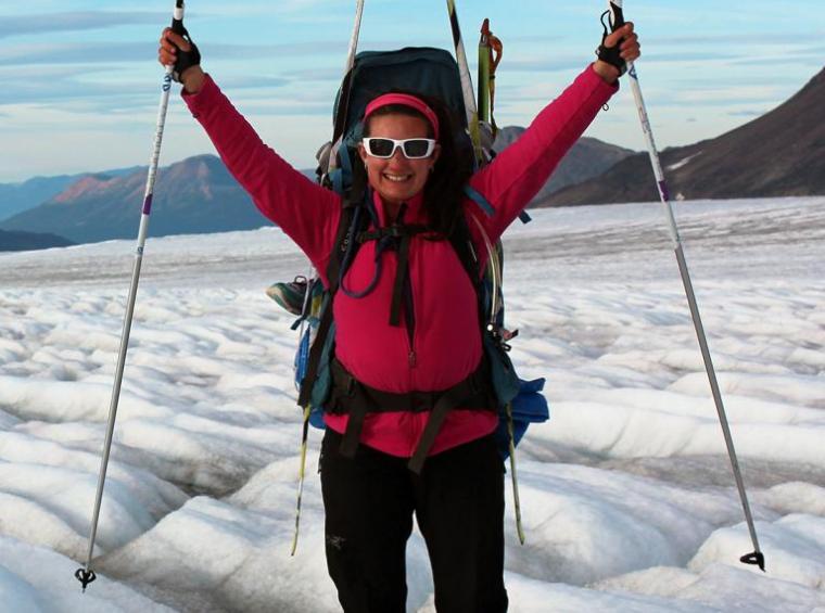 Laurissa wearing sunglasses and outdoor gear while treking on a glacier