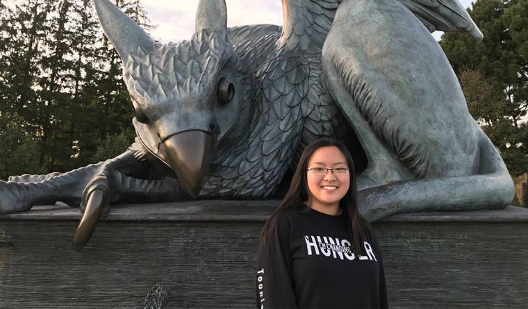 Head shot of Mandy Lam standing in front of the Gryphon statue.