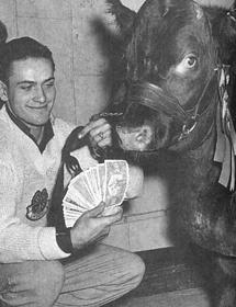 Black and white photo of Murray Andrew Gaunt holding cash in front of a cow.