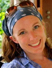 Headshot of Nikki Whaites wearing blue bandana and sunglasses on head.