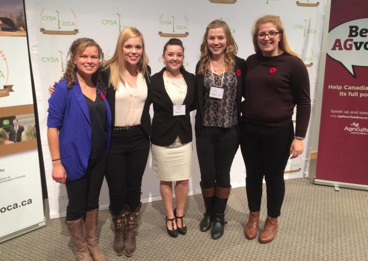 Five female students stand infront of CYSA backdrop
