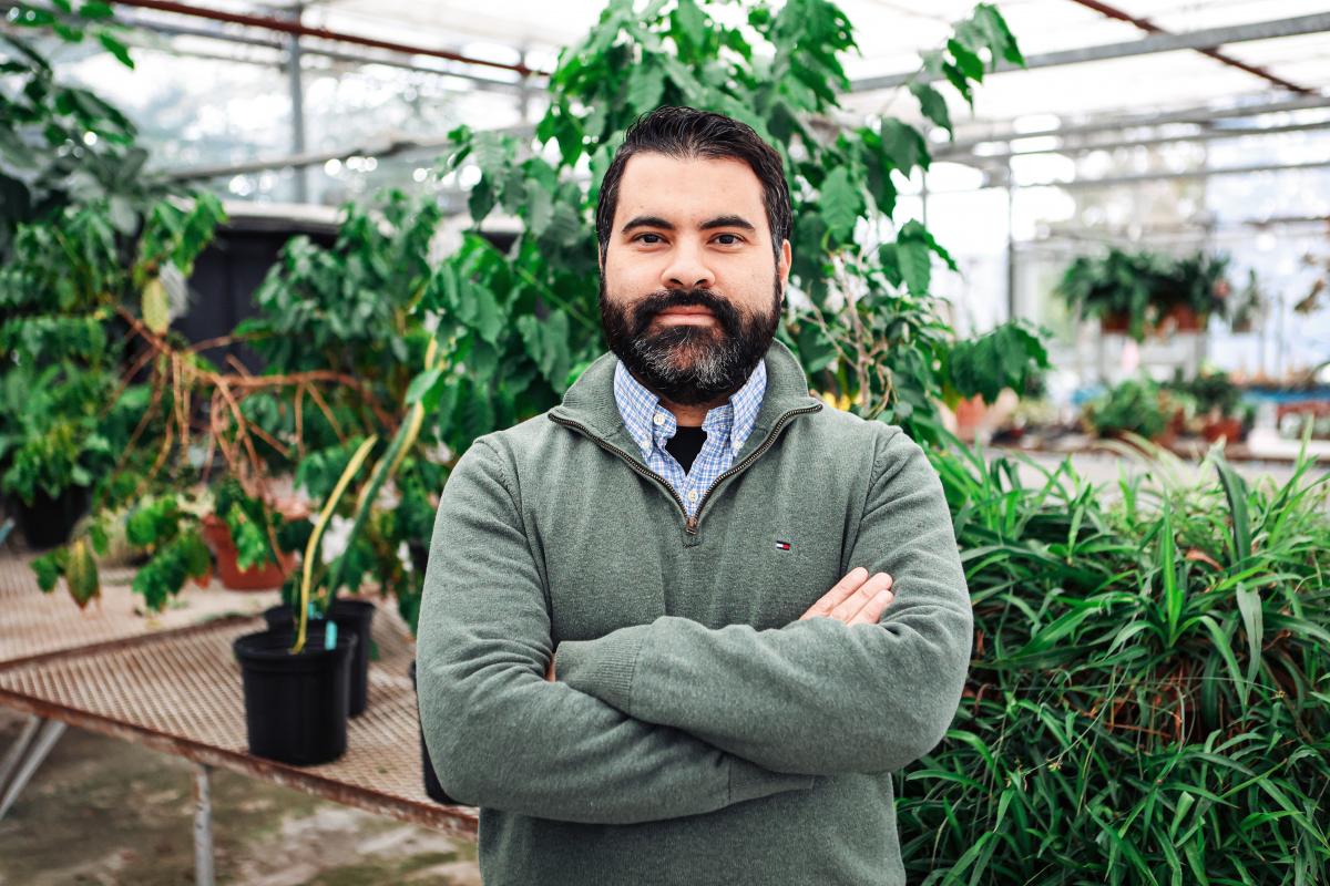 Adrian Correndo poses for the camera in the Bovey greenhouse