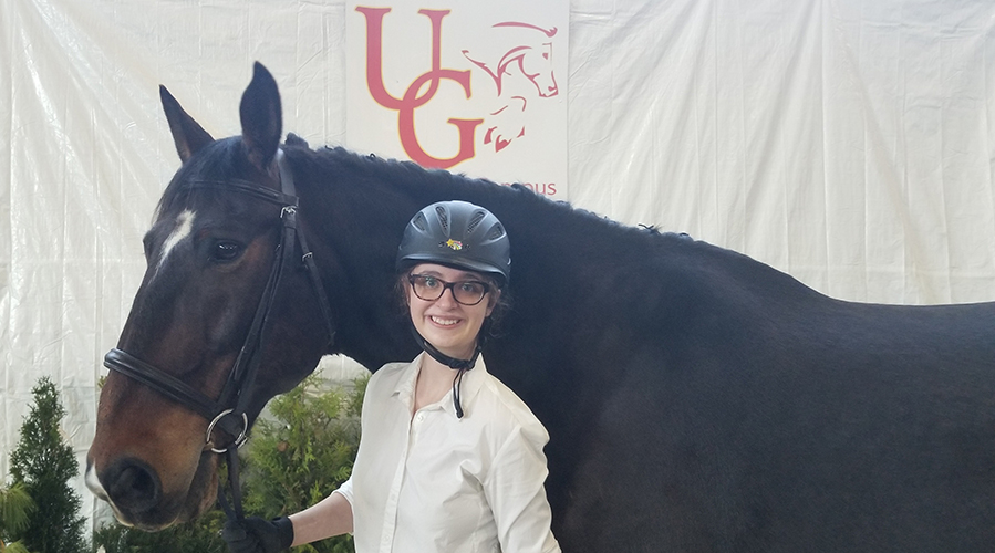 Alexa standing alongside a horse.