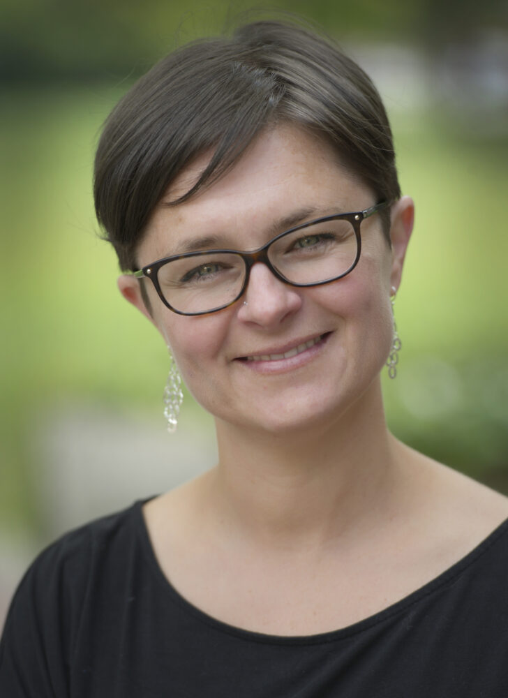 dr. anna kate shoveller standing outside in a green space